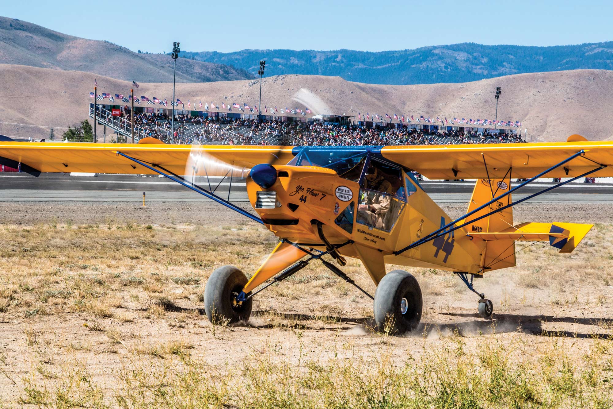 airplane in front of crowd stands