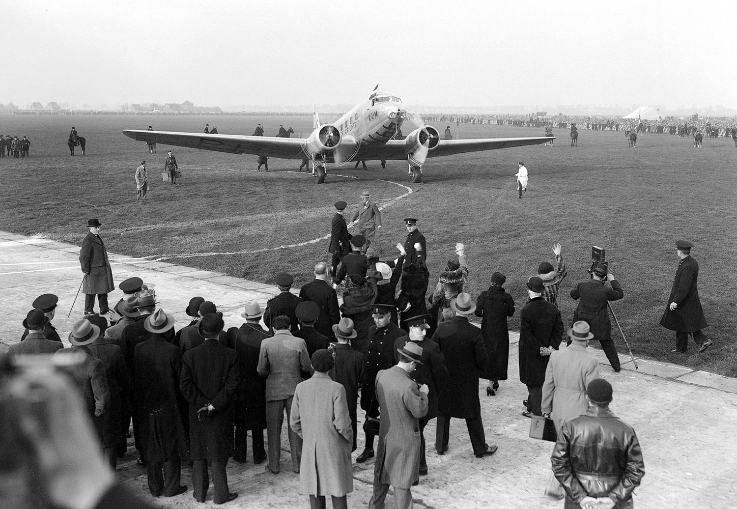 crowd in front of a Douglas DC-2 airplane